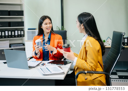 Businesswomen work and discuss their business plans. A woman employee explains Businesswomen work and discuss their business plans. A woman employee explains 131778553