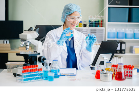 female scientist working with micro pipettes analyzing biochemical 131778635