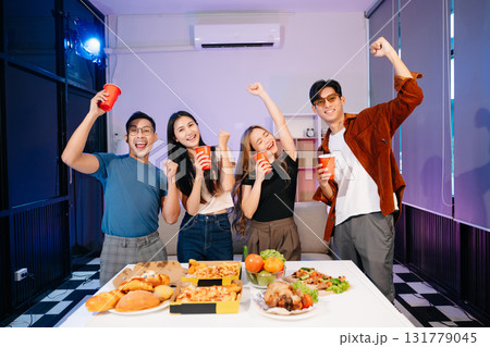 Celebration with friends enjoying food, drinks, and laughter at a lively house party. Perfect for themes of joy 131779045