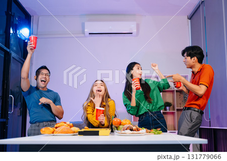 Celebration with friends enjoying food, drinks, and laughter at a lively house party. Perfect for themes of joy Celebration with friends enjoying food, drinks, and laughter at a lively house party. Perfect for themes of joy 131779066