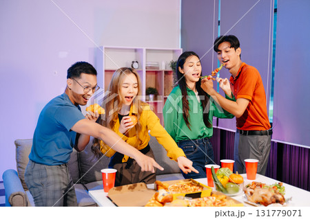 Celebration with friends enjoying food, drinks, and laughter at a lively house party. Perfect for themes of joy 131779071