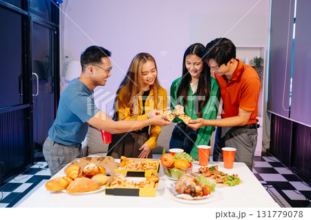 Celebration with friends enjoying food, drinks, and laughter at a lively house party. Perfect for themes of joy Celebration with friends enjoying food, drinks, and laughter at a lively house party. Perfect for themes of joy 131779078