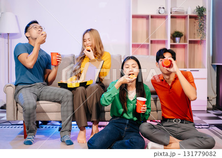 Celebration with friends enjoying food, drinks, and laughter at a lively house party. Perfect for themes of joy Celebration with friends enjoying food, drinks, and laughter at a lively house party. Perfect for themes of joy 131779082