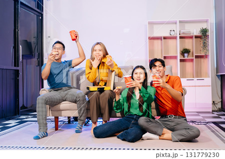 Celebration with friends enjoying food, drinks, and laughter at a lively house party. Perfect for themes of joy Celebration with friends enjoying food, drinks, and laughter at a lively house party. Perfect for themes of joy 131779230