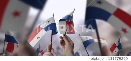 Panama flags in their hands on a blurred urban background 131779290
