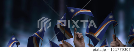 Marshall flags in their hands on a blurred urban background Marshall flags in their hands on a blurred urban background 131779307