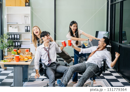 Lively office party with coworkers celebrating, enjoying pizza and drinks, and fostering team spirit 131779364