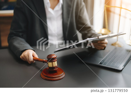 justice and law concept.Male judge in a courtroom on wooden table and Counselor or Male lawyer working 131779550