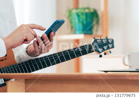 ギターを弾く男性の手元 131779675