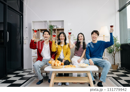 Group of Young Asian friend having, enjoy evening party together at home. Attractive young man and woman having fun, eating food, celebrate at home Group of Young Asian friend having, enjoy evening party together at home. Attractive young man and woman having fun, eating food, celebrate at home 131779942