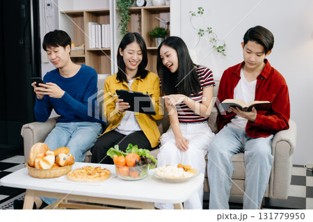 Group of Young Asian friend having, enjoy evening party together at home. Attractive young man and woman having fun, eating food, celebrate at home 131779950