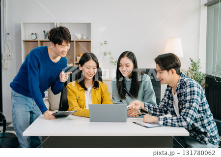 Group of young Asian college students working on his project assignment, using laptop computer and tablet an online informations. together, enjoy talking 131780062