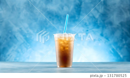 Refreshing iced beverage with blue straw set against a soft blue background indoors Refreshing iced beverage with blue straw set against a soft blue background indoors 131780525