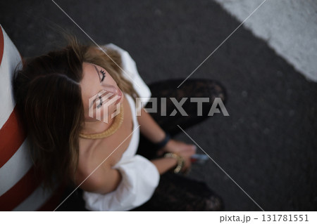 Woman posing on the road wearing fashionable clothes Woman posing on the road wearing fashionable clothes 131781551