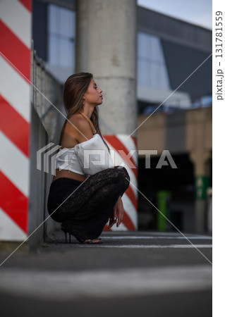 Woman posing on the road wearing fashionable clothes 131781559