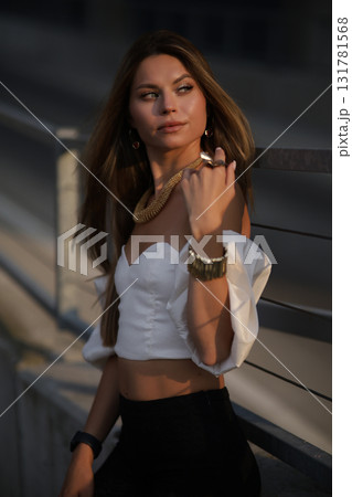 Woman posing on the road wearing fashionable clothes Woman posing on the road wearing fashionable clothes 131781568