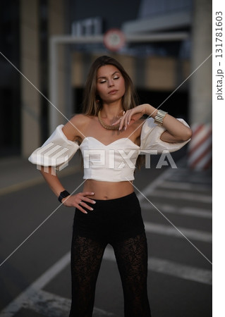 Woman posing on the road wearing fashionable clothes 131781603