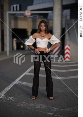Woman posing on the road wearing fashionable clothes 131781611