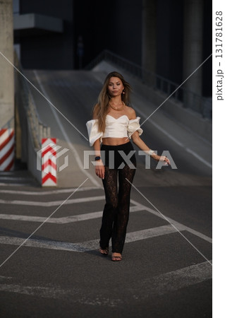 Woman posing on the road wearing fashionable clothes 131781628