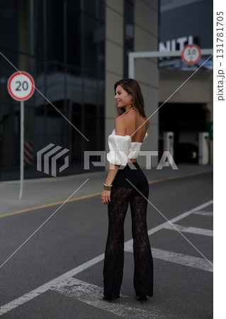 Woman posing on the road wearing fashionable clothes 131781705