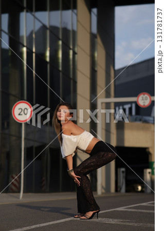 Woman posing on the road wearing fashionable clothes Woman posing on the road wearing fashionable clothes 131781737