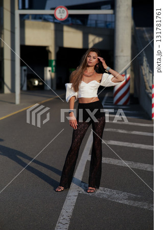 Woman posing on the road wearing fashionable clothes 131781761