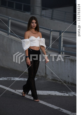 Woman posing on the road wearing fashionable clothes 131781814