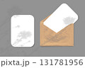 The shadow of wildflowers falls on an envelope with two sheets of textured white paper on a gray background. Mockup horizontal orientation. 131781956