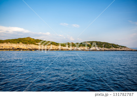 Uninhabited islands of the Lastovo National Park surrounded by calm sea in Croatia. Nature reserve, remote landscape and Mediterranean summer escape Uninhabited islands of the Lastovo National Park surrounded by calm sea in Croatia. Nature reserve, remote landscape and Mediterranean summer escape 131782787