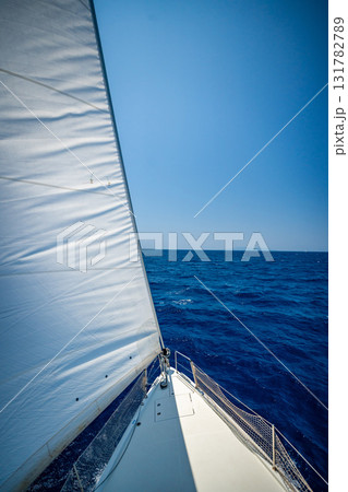 View from the mast down to the bow of a sailing yacht moving under full sails near Croatia. Freedom, adventure, yachting lifestyle and dynamic sea travel. 131782789