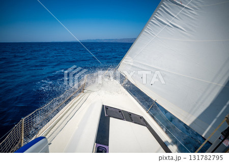 Bow of a sailing yacht cutting through the sea with sails fully open near Croatia. Freedom, motion, clean energy and slow travel on the open water. 131782795