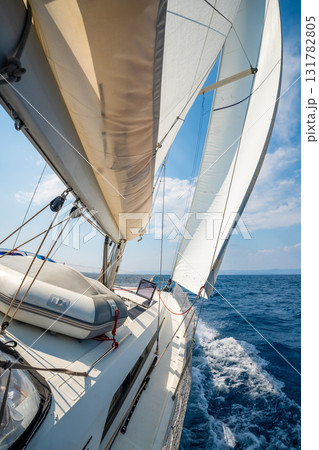 Side of a sailing yacht cutting through the sea with full sails near Croatia. Motion, freedom, sailing lifestyle and adventure on the open water. 131782805