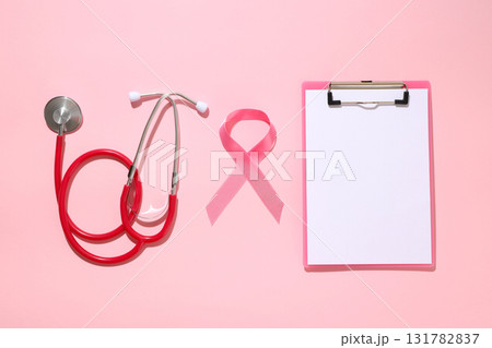 Medical stethoscope and pink ribbon on a light background Medical stethoscope and pink ribbon on a light background 131782837