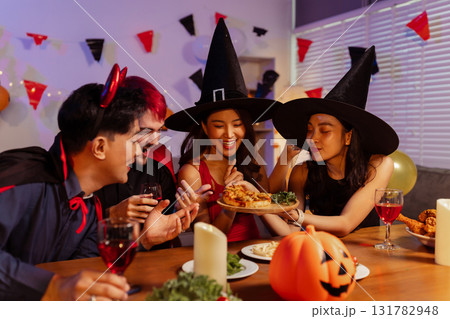 Dinner and group of people celebrating together at Halloween party. Dinner and group of people celebrating together at Halloween party. 131782948