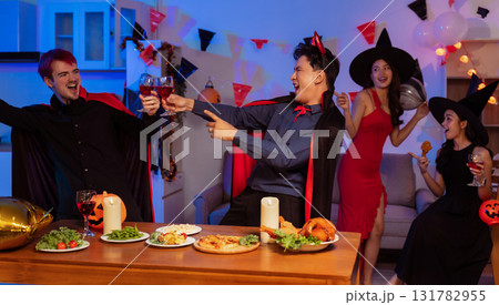 Dinner and group of people celebrating together at Halloween party. Dinner and group of people celebrating together at Halloween party. 131782955