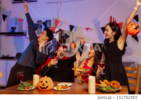 Dinner and group of people celebrating together at Halloween party. Dinner and group of people celebrating together at Halloween party. 131782965