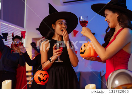 Dinner and group of people celebrating together at Halloween party. Dinner and group of people celebrating together at Halloween party. 131782966