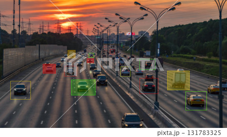 A busy highway with cars and a sunset in the background 131783325