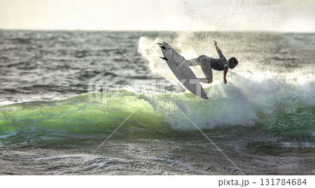 Surfer ride the wave  IN JUMP,   slashes 131784684