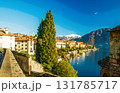 nICE VIEW ON  coastline of  lAKE Como: : boats moored by shore - Alps in distance nICE VIEW ON  coastline of  lAKE Como: : boats moored by shore - Alps in distance 131785717