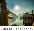 Fantastic view on cypress trees and part of building and mountains- Italian Alps  and lake Como at winter ( Christmas holidays) Fantastic view on cypress trees and part of building and mountains- Italian Alps  and lake Como at winter ( Christmas holidays) 131785734