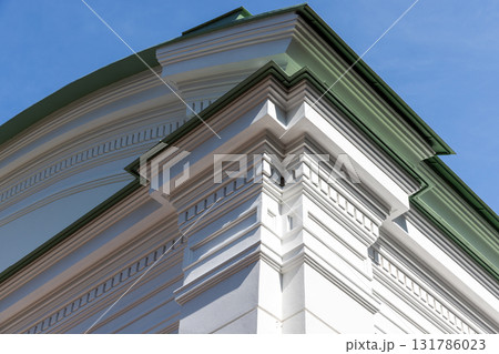 Close-up of a classical building corner featuring white decorative molding 131786023