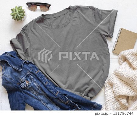 Blank gray unisex t-shirt near accessories on white wooden board top view, Mockup 131786744