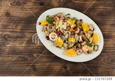 Plate of delicious fruit salad with seafood. Plate of delicious fruit salad with seafood. 131787209