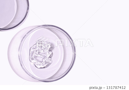 A sample of skin serum or moisturizing gel in a Petri dish. A cosmetic product. Copy space 131787412