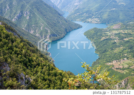 Canyon river meandering among green forested mountains, nature landscape photography under blue sky Canyon river meandering among green forested mountains, nature landscape photography under blue sky 131787512