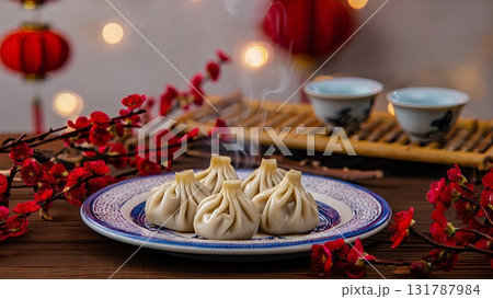 Steaming traditional pork dumplings on wooden table with festive chinese new year decor, including red lanterns, asian cuisine concept Steaming traditional pork dumplings on wooden table with festive chinese new year decor, including red lanterns, asian cuisine concept 131787984