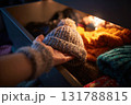 Hand Reaching for Cozy Beanie in Drawer of Winter Accessories 131788815