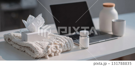 Office Desk with Tissues, Medicine, and Laptop for Remote Work During Illness 131788835