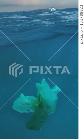 Plastic debris floating in clean ocean water under sunlight Plastic debris floating in clean ocean water under sunlight 131788923